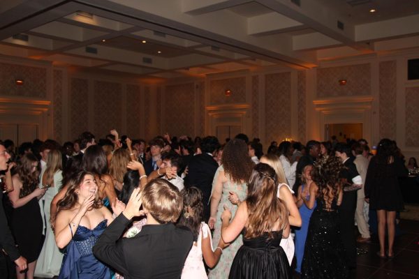 Seniors gather on the dance floor at Founders Inn during Ocean Lakes’ prom. The ballroom was illuminated by fairy lights on table centerpieces and mini disco balls lining the walls. Photo taken by junior volunteer Anna Orchard-Hays on May 30. 
